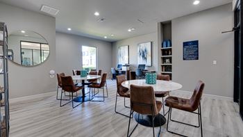 the reserve at bucklin hill clubhouse with tables and chairs  at Highland Luxury Living, Lewisville, Texas